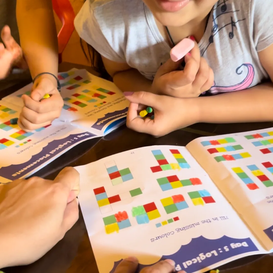 Child solving logic puzzles in a Logicoland puzzle book